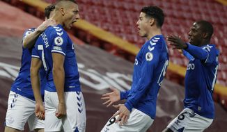 Everton&#x27;s Richarlison, second left celebrates with teammates after scoring the opening goal of the game during the English Premier League soccer match between Liverpool and Everton at Anfield in Liverpool, England, Saturday, Feb. 20, 2021. (Phil Noble/ Pool via AP)