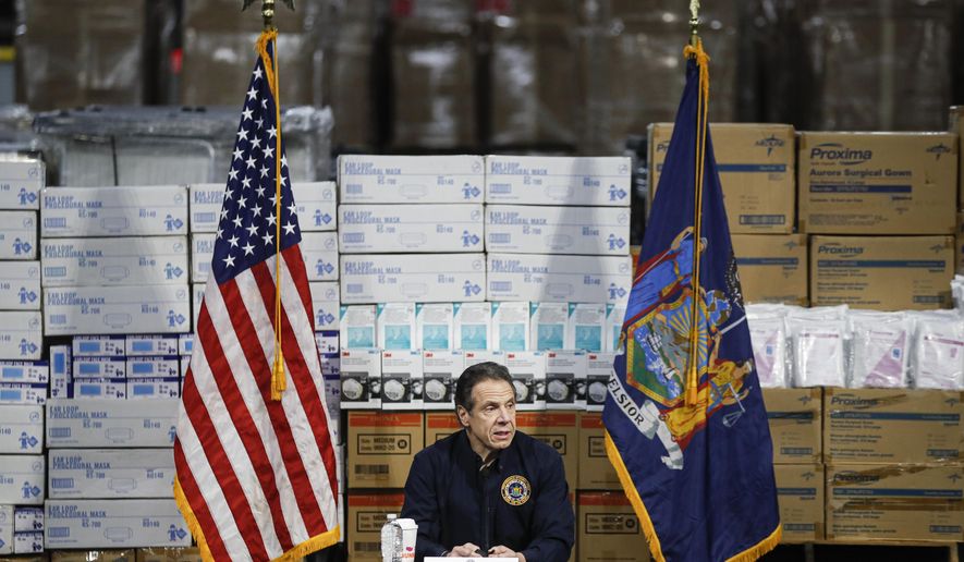 FILE - In this March 24, 2020 file photo, Gov. Andrew Cuomo speaks during a news conference against a backdrop of medical supplies at the Jacob Javits Center that will house a temporary hospital in response to the COVID-19 outbreak in New York. (AP Photo/John Minchillo, File)