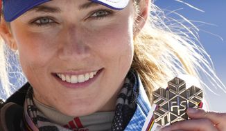 United States&#39; Mikaela Shiffrin shows her bronze medal of the women&#39;s slalom, at the alpine ski World Championships in Cortina d&#39;Ampezzo, Italy, Saturday, Feb. 20, 2021. (AP Photo/Giovanni Auletta)