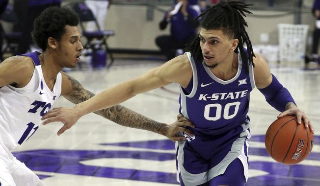 TCU guard Taryn Todd (11) defends against Kansas State guard Mike McGuirl (00) during the second half of an NCAA college basketball game Saturday, Feb. 20, 2021, in Fort Worth, Texas. (AP Photo/Richard W. Rodriguez)