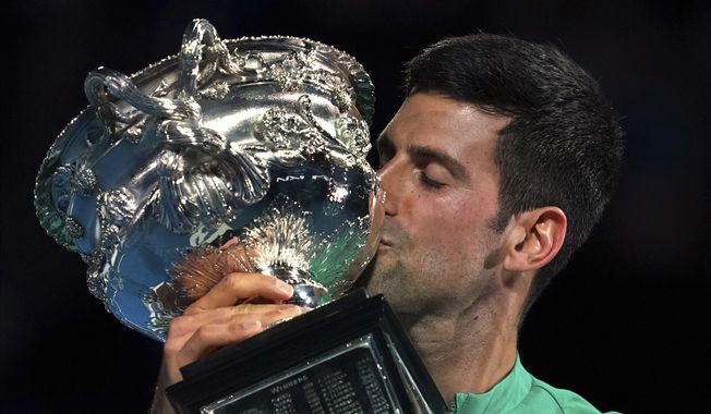 Serbia&#x27;s Novak Djokovic kisses the Norman Brookes Challenge Cup after defeating Russia&#x27;s Daniil Medvedev in the men&#x27;s singles final at the Australian Open tennis championship in Melbourne, Australia, Sunday, Feb. 21, 2021.(AP Photo/Mark Dadswell)