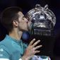 Serbia&#39;s Novak Djokovic kisses the Norman Brookes Challenge Cup after defeating Russia&#39;s Daniil Medvedev in the men&#39;s singles final at the Australian Open tennis championship in Melbourne, Australia, Sunday, Feb. 21, 2021.(AP Photo/Mark Dadswell)
