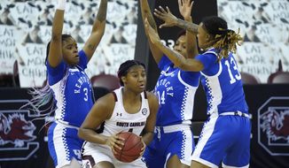 South Carolina forward Aliyah Boston (4) is surrounded by Kentucky forward Keke McKinney (3), Tatyana Wyatt (14), and Chasity Patterson (15) during the first half of an NCAA college basketball game Sunday, Feb. 21, 2021, in Columbia, S.C. (AP Photo/Sean Rayford)