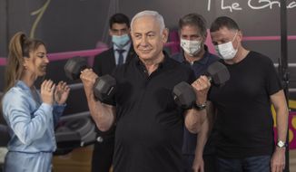 Israeli Prime Minister Benjamin Netanyahu  and Health Minister Yuli Edelstein visits Fitness gym ahead of the re-opening of the branch in Petah Tikva, Israel on Saturday, Feb. 20, 2021.  (AP Photo/Tal Shahar, Yediot Ahronot, Pool)