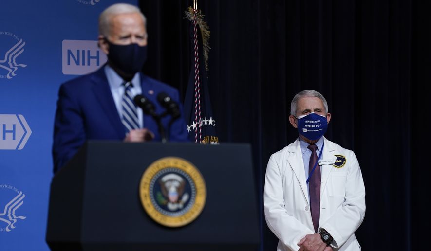 President Joe Biden speaks during a visit to the Viral Pathogenesis Laboratory at the National Institutes of Health, Thursday, Feb. 11, 2021, in Bethesda, Md. Dr. Anthony Fauci, director of the National Institute of Allergy and Infectious Diseases, listens at right. (AP Photo/Evan Vucci)