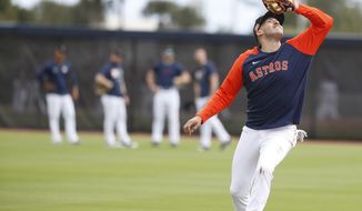 Houston Astros shortstop Carlos Correa catches a pop out during spring training baseball in West Palm Beach, Fla., Monday, Feb. 22, 2021. (Karen Warren/Houston Chronicle via AP)