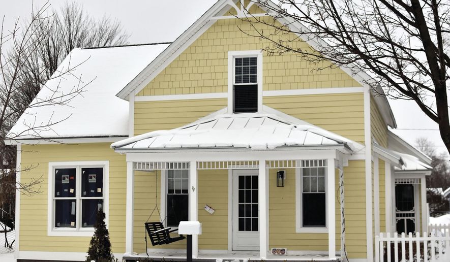 Keith and Suzette Kolfage, the owners of 508 N. Robert St., in Ludington, Mich., shown on Tuesday, Feb. 9, 2021, found historical items while renovating during the past few months. When the Kolfages, latest owners of the house started to open up walls to make updates, they also found more than plaster dust. "We found stenciling on the boards (in the walls). "There was a logo and a company name. It was for a hat maker in New York City. The address on it still exists in lower Manhattan." (Hannah Hubbard/Ludington Daily News via AP)