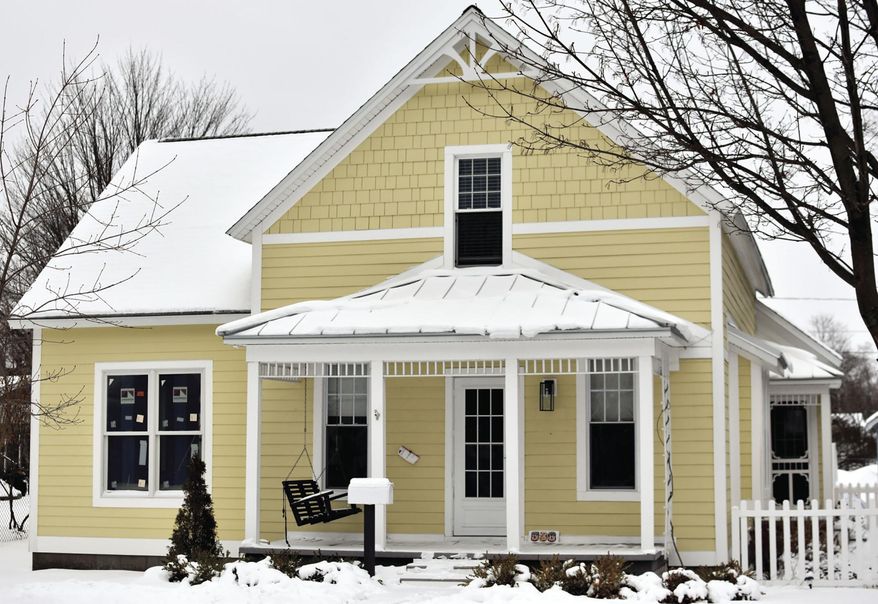 Keith and Suzette Kolfage, the owners of 508 N. Robert St., in Ludington, Mich., shown on Tuesday, Feb. 9, 2021, found historical items while renovating during the past few months. When the Kolfages, latest owners of the house started to open up walls to make updates, they also found more than plaster dust. "We found stenciling on the boards (in the walls). "There was a logo and a company name. It was for a hat maker in New York City. The address on it still exists in lower Manhattan." (Hannah Hubbard/Ludington Daily News via AP)