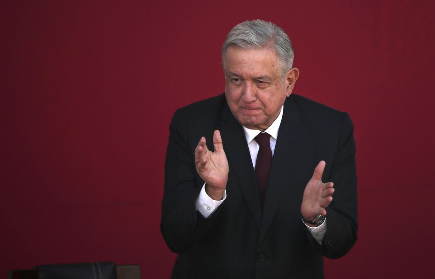 Mexican President Andres Manuel Lopez Obrador applauds during a ceremony marking the 108th anniversary of the Marcha de la Lealtad or March of Loyalty, at Chapultepec Castle in Mexico City, Tuesday, Feb. 9, 2021. The ceremony commemorates the day in 1913 when hundreds of military cadets accompanied democratically elected president Francisco I. Maduro from Chapultepec Castle to the National Palace at the start of a coup known as the "Decena Tragica,” or Ten Tragic Days. (AP Photo/Marco Ugarte)