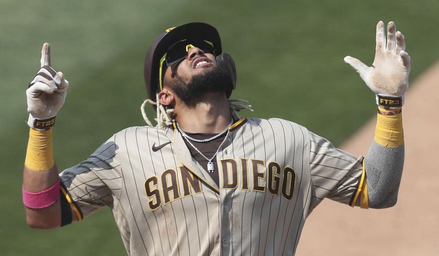 FILE - San Diego Padres&#39; Fernando Tatis Jr. celebrates after hitting a solo home run against the Oakland Athletics during the seventh inning of a baseball game in Oakland, Calif., in this Sunday, Sept. 6, 2020, file photo. The 22-year-old star shortstop signed a $340 million, 14-year deal with the San Diego Padres, the third-highest deal in the sport&#39;s history. But the son of the only major leaguer to hit two grand slams in one inning will be giving up a percentage of his fortune to Big League Advance, a company founded in 2016 by former minor league pitcher Michael Schwimer to invest in prospects seeking an appreciation. (AP Photo/Jed Jacobsohn, File)