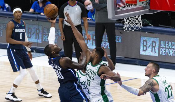 Dallas Mavericks forward Dorian Finney-Smith (10) shoots as Boston Celtics forward Tristan Thompson (13) defends during the second half of an NBA basketball game in Dallas, Tuesday, Feb. 23, 2021. (AP Photo/Sam Hodde)