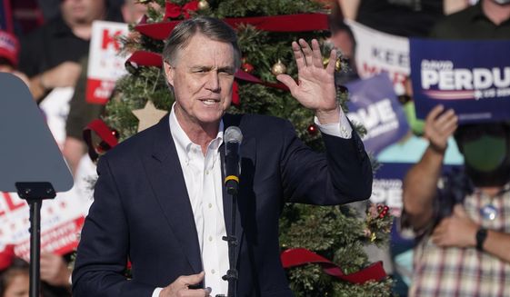 FILE - In this Dec. 10, 2020 file photo, Sen. David Perdue, R-Ga., speaks during a &amp;quot;Save the Majority&amp;quot; rally in Augusta, Ga.  Perdue says he won’t run in 2022 to reclaim a seat in the U.S. Senate. The announcement came Tuesday, Feb. 23, 2021, eight days after the defeated Republican filed campaign paperwork that could have opened the way for him to run against Democratic Sen. Raphael Warnock.(AP Photo/John Bazemore, File)