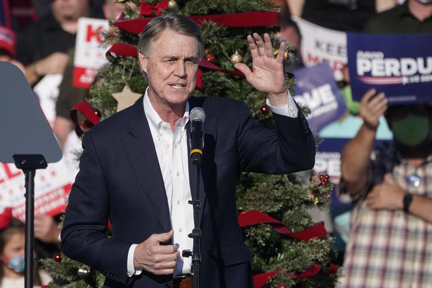 FILE - In this Dec. 10, 2020 file photo, Sen. David Perdue, R-Ga., speaks during a &amp;quot;Save the Majority&amp;quot; rally in Augusta, Ga.  Perdue says he won’t run in 2022 to reclaim a seat in the U.S. Senate. The announcement came Tuesday, Feb. 23, 2021, eight days after the defeated Republican filed campaign paperwork that could have opened the way for him to run against Democratic Sen. Raphael Warnock.(AP Photo/John Bazemore, File)