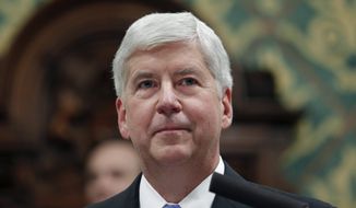 FILE - In this Jan. 23, 2018, file photo, then, Michigan Gov. Rick Snyder delivers his State of the State address at the state Capitol in Lansing, Mich. A pretrial hearing is scheduled Tuesday, Feb. 23, 2021, for Snyder, who is accused of two misdemeanor counts of willful neglect of duty in connection with the lead contamination of drinking water in Flint, Mich., and a fatal outbreak of Legionnaires&#39; disease. (AP Photo/Al Goldis, File)