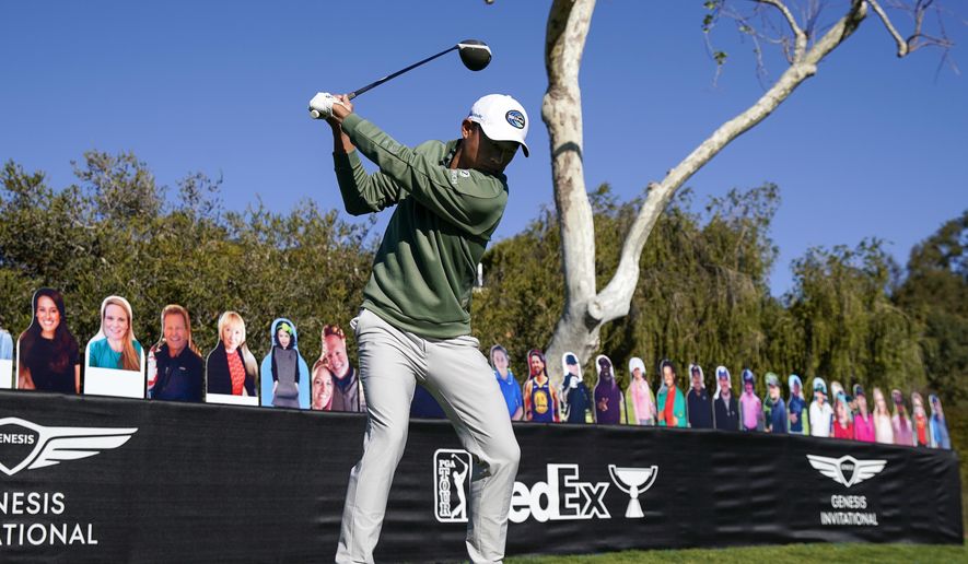 Collin Morikawa tees off on the 18th hole in front of cardboard cutout fans during the Genesis Invitational pro-am golf event at Riviera Country Club, Wednesday, Feb. 17, 2021, in the Pacific Palisades area of Los Angeles. (AP Photo/Ryan Kang)