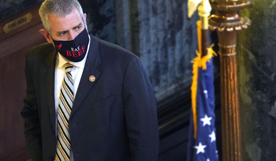 House Speaker Philip Gunn, R-Clinton, looks down the hall as he returns from lunch to the Capitol in Jackson, Miss., Wednesday, Feb. 3, 2021. Some legislators have taken to wearing logo bearing, fashionable masks or message bearing masks as opposed to the government provided surgical-type masks. (AP Photo/Rogelio V. Solis) .