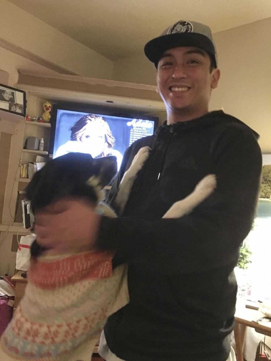 Navy veteran Angelo Quinto smiles at his home in Berkeley, Calif. Quinto who was going through an episode of paranoia died after a Northern California police officer knelt on his neck for several minutes, his family said Tuesday, Feb. 23, 2021. (Isabella Collins via AP)