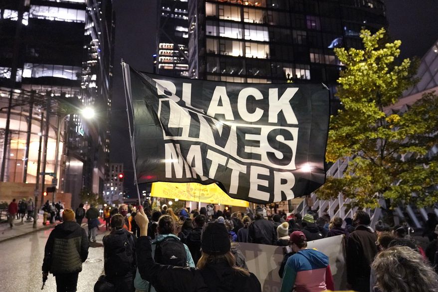 In this Nov. 4, 2020, photo, protesters representing Black Lives Matter and Protect the Results march in Seattle. A financial snapshot shared exclusively with The Associated Press shows the Black Lives Matter Global Network Foundation raked in just over $90 million last year. (AP Photo/Ted S. Warren) **FILE**