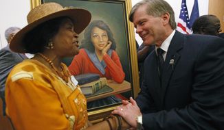 FILE - In this Sept. 17, 2010, file photo, Joan Cobbs, left, sister of civil rights legend Barbara Johns, shakes hands with Virginia Gov. Bob McDonnell, right, after a portrait of Barbara Johns, center, was unveiled in the Virginia State Capitol in Richmond, Va. There will soon be a statue saluting Virginia’s Barbara Johns, a 16-year-old Black girl who staged a strike in 1951 over unequal conditions at her segregated high school in Farmville. Her actions led to court-ordered integration of public schools across the U.S, via the landmark Supreme Court decision, Brown v. Board of Education. (Bob Brown/Richmond Times-Dispatch via AP)