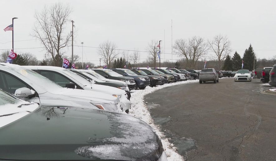 In this image made from video, cars drive through the used vehicle lot at a LaFontaine auto dealership in Fenton Township, Mich., Thursday, Jan. 28, 2021. A chain reaction touched off by the coronavirus pandemic has pushed new-vehicle prices to record highs and dramatically driven up the cost of used ones. (AP Photo/Mike Householder)