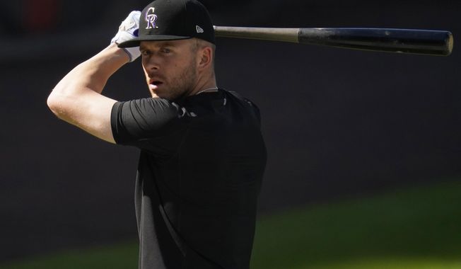 FILE - Colorado Rockies shortstop Trevor Story warms up before a baseball game against the Los Angeles Angels in this file photograph taken Saturday, Sept. 12, 2020, in Denver. Story, who will be a free agent at the end of the 2021 season, has become the face of the franchise with the trade of third baseman Nolan Arenado to St. Louis. (AP Photo/David Zalubowski, File)