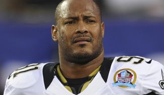FILE - In this Dec. 9, 2012, file photo, New Orleans Saints defensive end Will Smith appears before an NFL football game against the New York Giants in East Rutherford, N.J. A lawyer for the man who fatally shot former NFL star Will Smith in 2016 said Tuesday, Feb. 23, 2021 he&#39;ll seek the man&#39;s release on bond now that a Louisiana appeals court has officially vacated the manslaughter conviction by a non-unanimous jury.  (AP Photo/Bill Kostroun, File)