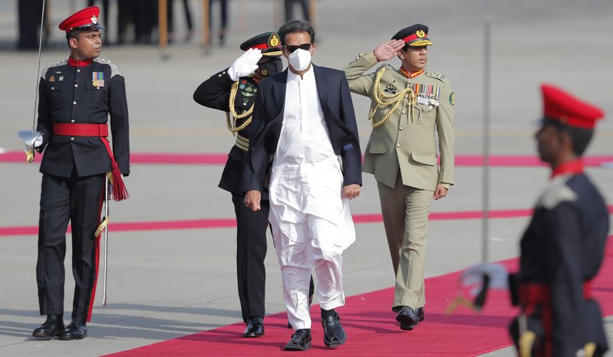 Pakistan&#x27;s Prime Minister Imran Khan inspects a Guard of Honor upon his arrival in Colombo, Sri Lanka, Tuesday, Feb. 23, 2021. Khan is in Sri Lanka for a two day official visit. (AP Photo/Eranga Jayawardena)