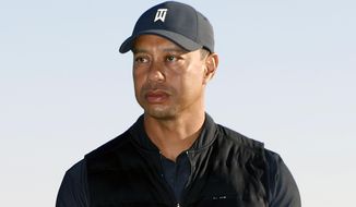 FILE - Tiger Woods looks on during the trophy ceremony on the practice green after the final round of the Genesis Invitational golf tournament at Riviera Country Club, Sunday, Feb. 21, 2021, in the Pacific Palisades area of Los Angeles. Woods was injured Tuesday, Feb. 23, 2021, in a vehicle rollover in Los Angeles County and had to be extricated from the vehicle with the “jaws of life” tools, the Los Angeles County Sheriff’s Department said.(AP Photo/Ryan Kang)