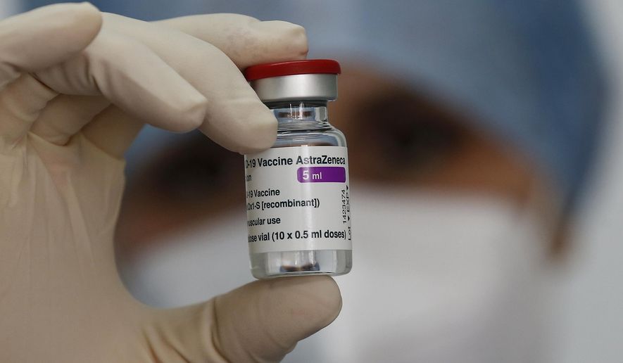 A health worker holds up a dose of the AstraZeneca vaccine against COVID-19 to be administered to members of the Italian Army at a vaccination center set up at the military barracks of Cecchignola, in Rome, Tuesday, Feb. 23, 2020.  (Cecilia Fabiano/LaPresse via AP)