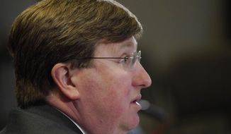 Gov. Tate Reeves answers a reporter&#39;s question during his media update on the current situation of COVID-19 in Mississippi, Tuesday, Feb. 23, 2021, in Jackson, Miss. (AP Photo/Rogelio V. Solis)