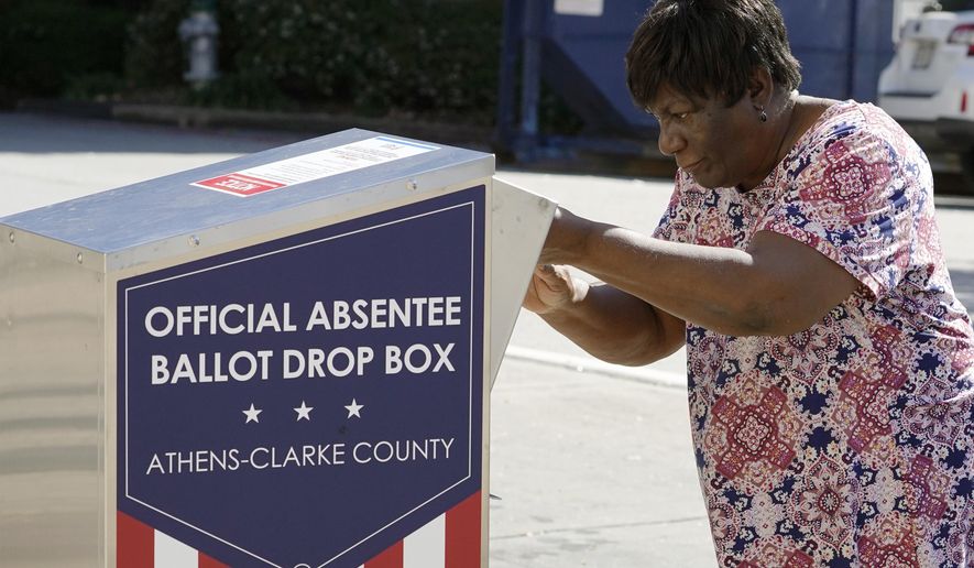 In this Oct. 19, 2020, file photo, a voter drops their ballot off during early voting in Athens, Ga. After record turnout led to stunning GOP losses in the once reliably red state, Republican lawmakers are forging ahead with an aggressive slate of voting legislation that critics argue is tailored toward curtailing the power of Black voters. (AP Photo/John Bazemore) ** FILE **