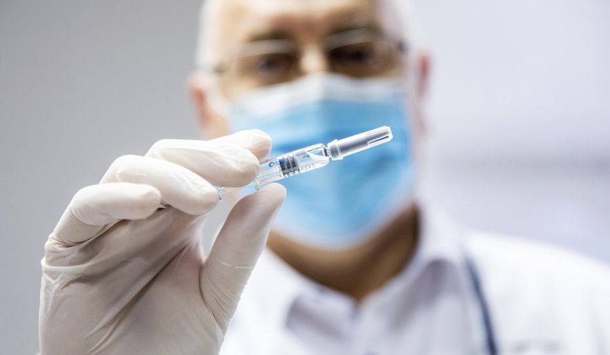 Csaba Lengyel, President of the University of Szeged&#39;s Szent-Gyorgyi Albert Clinic Center shows a vial of the vaccine against COVID-19 produced by Chinese Sinopharm at the university in Szeged, Hungary, Wednesday, February 24, 2021. (Tibor Rosta/MTI via AP)