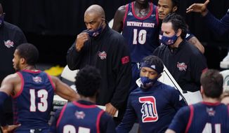 FILE- In a Dec. 4, 2020 file photo, Detroit Mercy head coach Mike Davis prepares to talk to his team during the first half of an NCAA college basketball game against Michigan State, in East Lansing, Mich. In a college basketball season unlike any other, players have had to adjust to coronavirus protocols and just general anxiety about what&#39;s to come. Even for those who manage to avoid catching the virus, the mental strain can be a real issue. Detroit Mercy&#39;s men&#39;s basketball program paused activities earlier this season, citing the mental health of its players. (AP Photo/Carlos Osorio, File)