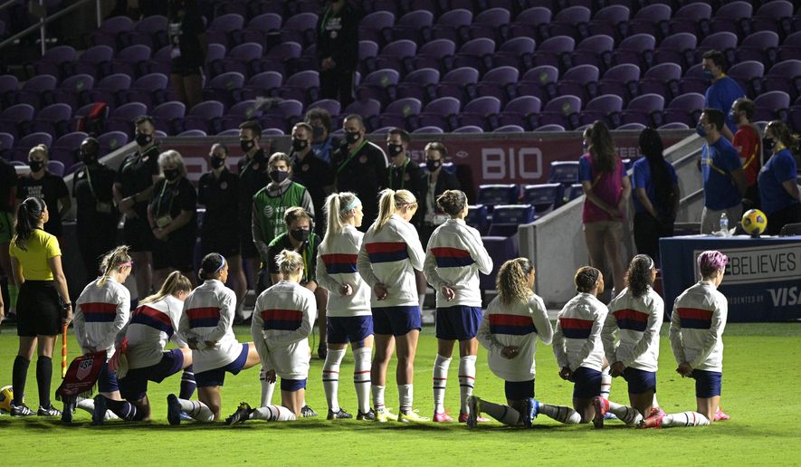 Some members of the United States team kneel during the playing of the national anthem before a SheBelieves Cup women&#39;s soccer match against Canada, Thursday, Feb. 18, 2021, in Orlando, Fla. (AP Photo/Phelan M. Ebenhack) **FILE**