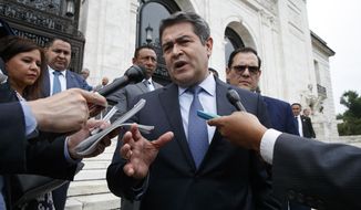 FILE - In this Aug. 13, 2019 file photo, Honduran President Juan Orlando Hernandez speaks to the reporters as he leaves a meeting at the Organization of American States, in Washington.  Newly proposed U.S. legislation introduced Tuesday, Feb. 23, 2021, targets Orlando Hernandez as allegations of ties to drug trafficking grow. (AP Photo/Jacquelyn Martin, File)