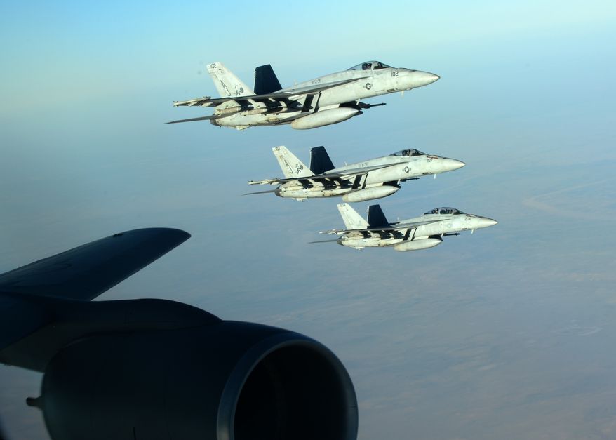 A formation of U.S. Navy F-18E Super Hornets leaves after receiving fuel from a KC-135 Stratotanker over northern Iraq, Sept. 23, 2014. These aircraft were part of a large coalition strike package that was the first to strike ISIL targets in Syria. (U.S. Air Force photo by Staff Sgt. Shawn Nickel)