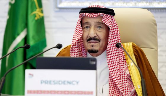 In this Nov. 21, 2020, handout image provided by Saudi Royal Palace, Saudi King Salman gives his opening remarks at a virtual G20 summit hosted by Saudi Arabia and held over video conference amid the COVID-19 pandemic, in Riyadh, Saudi Arabia.  President Joe Biden is expected to speak to Saudi King Salman for the first time in Biden’s just over a month-old administration. Coming as soon as Thursday, the conversation between the two strategic partners will be overshadowed by the expected release of U.S. intelligence findings on whether the king’s son approved the killing of a U.S.-based Saudi journalist. (Bandar Aljaloud/Saudi Royal Palace via AP)