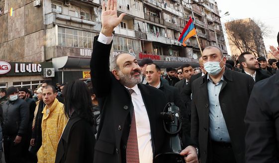 Armenian Prime Minister Nikol Pashinyan waves to supporters during a rally in his support in the center of Yerevan, Armenia, Thursday, Feb. 25, 2021. Armenia&#39;s prime minister has spoken of an attempted military coup after facing the military&#39;s General Staff demand for him to step down. The developments come after months of protests sparked by the nation&#39;s defeat in the Nagorno-Karabakh conflict with Azerbaijan. (Tigran Mehrabyan/PAN Photo via AP)