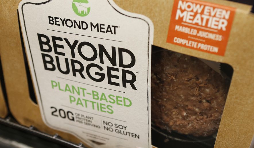 FILE - In this June 27, 2019, file photo, a meatless burger patty called Beyond Burger by Beyond Meat is displayed at a grocery store in Richmond, Va. Plant-based food company Beyond Meat will be partnering with several major fast food chains in the coming years to expand offerings that could eventually include plant-based burgers, chalupas or toppings on a stuffed-crust pizza. They announced on Thursday, Feb. 25, 2021, distribution agreements with McDonald&#39;s as well as with Yum Brands, the parent company of KFC, Taco Bell and Pizza Hut. (AP Photo/Steve Helber, File)