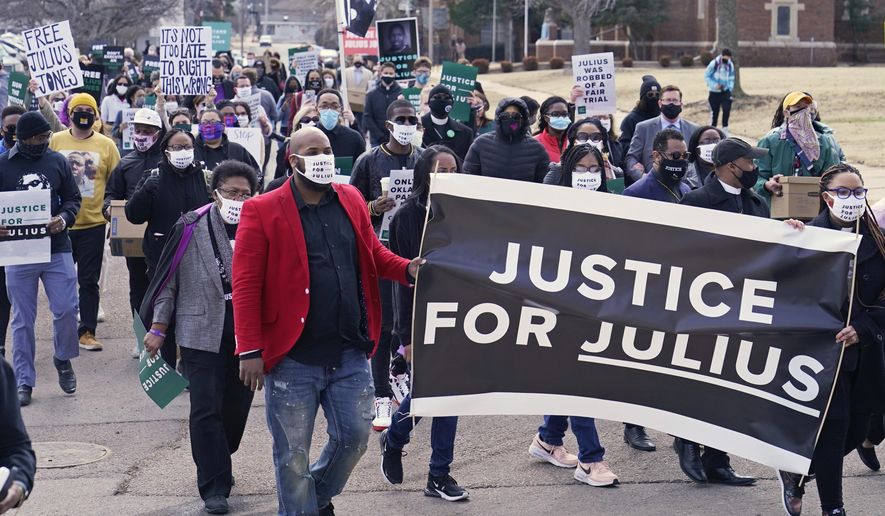 Supporters of Julius Jones, who has been on death row in Oklahoma since 1999, march to the offices of the Oklahoma Pardon and Parole Board, Thursday, Feb. 25, 2021, in Oklahoma City, where they presented a petition with over 6.2 million signatures, calling for Jones' death sentence to be commuted. (AP Photo/Sue Ogrocki)