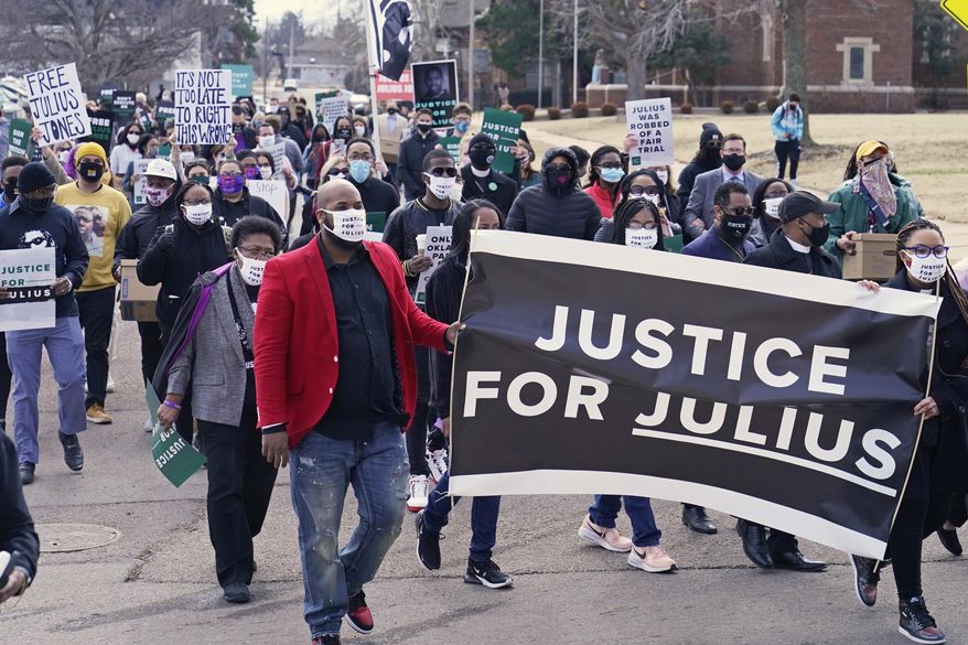 Supporters of Julius Jones, who has been on death row in Oklahoma since 1999, march to the offices of the Oklahoma Pardon and Parole Board, Thursday, Feb. 25, 2021, in Oklahoma City, where they presented a petition with over 6.2 million signatures, calling for Jones' death sentence to be commuted. (AP Photo/Sue Ogrocki)
