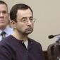 FILE - In this Jan. 24, 2018, file photo, Larry Nassar, a former doctor for USA Gymnastics and member of Michigan State&#39;s sports medicine staff, sits in court during his sentencing hearing in Lansing, Mich.  John Geddert, a former U.S. Olympics gymnastics coach, is being charged Thursday, Feb. 25, 2021, with crimes, including sexual assault, human trafficking and running a criminal enterprise is the latest fallout from the sexual abuse scandal involving Nassar. (AP Photo/Carlos Osorio, File)