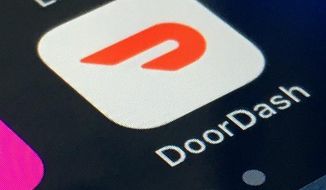FILE - The DoorDash app is shown on a smartphone on Feb. 27, 2020, in New York. Meal delivery company DoorDash said its revenue more than tripled last year thanks to pandemic-driven demand, but it still lost money because it spent more heavily on marketing and expanding its business. DoorDash reported a net loss of $312 million for the quarter that ended Dec. 31, 2020. (AP Photo, File)