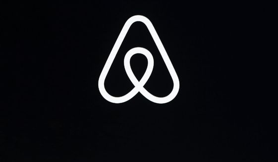 FILE - This Feb. 22, 2018, file photo shows an Airbnb logo during an event in San Francisco. Home-sharing site Airbnb posted a $3.9 billion loss in the fourth quarter of 2020 as it suffered from the pandemic downturn in travel and recorded one-time costs for becoming a public company. (AP Photo/Eric Risberg, File)