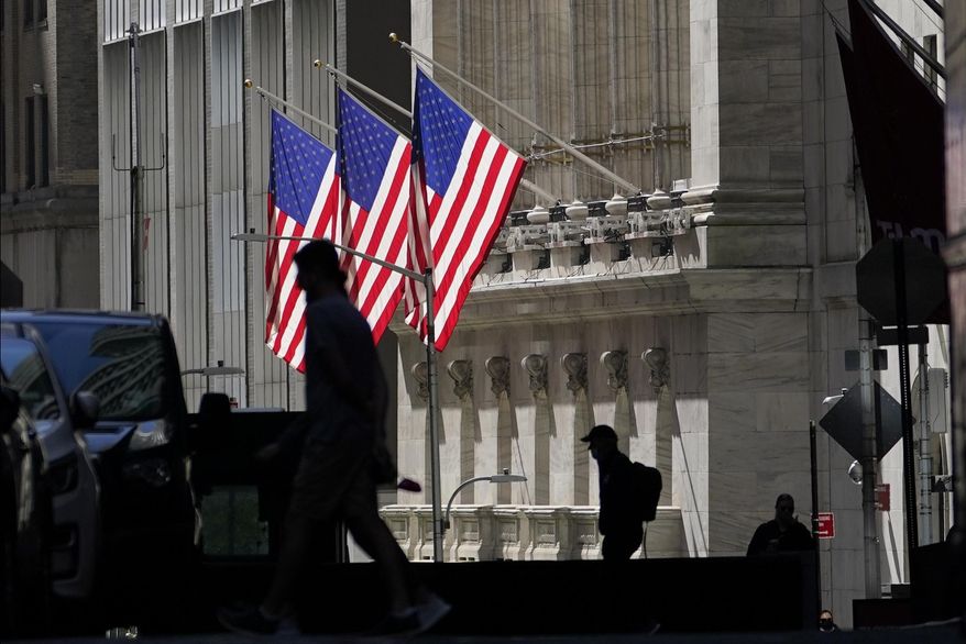 FILE - In this Oct. 14, 2020 file photo, pedestrians pass the New York Stock Exchange in New York. Stocks are off to a mostly lower start on Wall Street, led by drops in several big technology companies, while bond yields marched steadily higher as traders anticipate greater economic growth and more stimulus from Washington. (AP Photo/Frank Franklin II, File)
