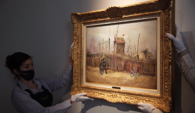 Sotheby&#x27;s personnel display « Scene de rue à Montmartre » (Street scene in Montmartre), a painting by Dutch master Vincent van Gogh at Sotheby&#x27;s auction house in Paris, Thursday, Feb. 25, 202. The artwork painted in 1887 is to be on public display for the first time ahead of an auction next month. It has remained in the same family collection for over 100 years, according to the auction house which did not reveal the identity of the owner. (AP Photo/Christophe Ena)