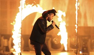 FILE - In this Sunday, Nov. 22, 2015, file photo, the Weeknd performs at the American Music Awards at the Microsoft Theater in Los Angeles. The Weeknd had the No. 1 song of 2020 but “Blinding Lights” was not nominated for a Grammy Award.  (Photo by Matt Sayles/Invision/AP, File)