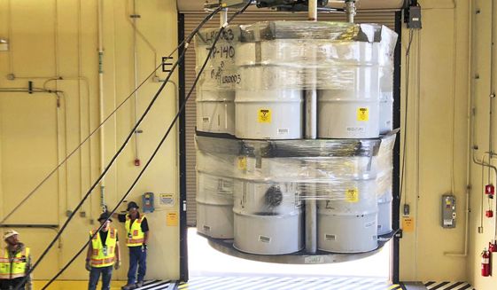 FILE - In this April 2019, file photo, provided by Los Alamos National Laboratory, barrels of radioactive waste are loaded for transport to the Waste Isolation Pilot Plant (WIPP) at the Radioactive Assay Nondestructive Testing (RANT) facility in Los Alamos, N.M. New Mexico is going after the federal government for failing to make progress on cleaning up contamination left behind by decades of bomb-making and nuclear research at one of the nation&#39;s premier nuclear labs. In a civil complaint filed in federal court, the state says the plan by the U.S. Energy Department lacks substantive and appropriate targets for dealing with waste at Los Alamos National Laboratory. (Nestor Trujillo/Los Alamos National Laboratory via AP, File)