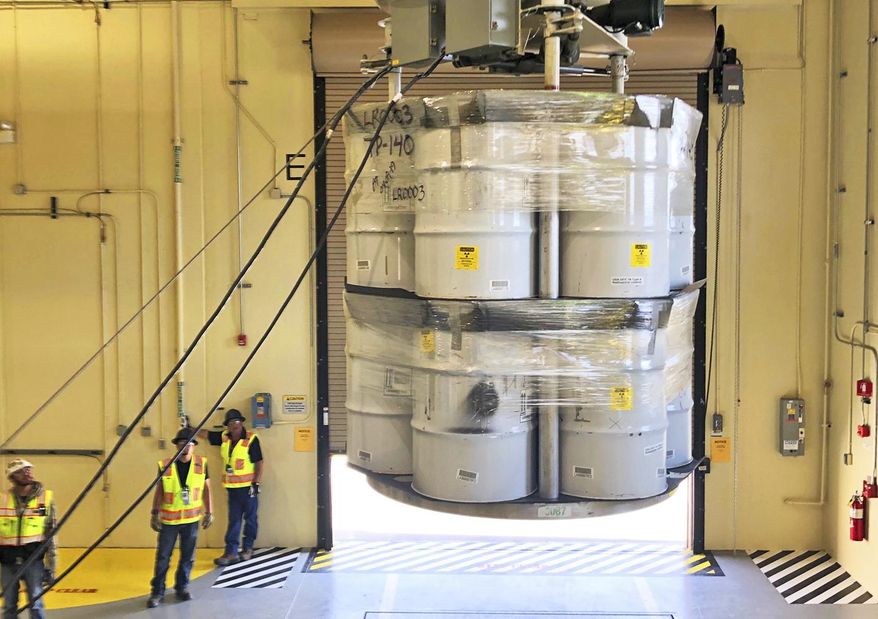FILE - In this April 2019, file photo, provided by Los Alamos National Laboratory, barrels of radioactive waste are loaded for transport to the Waste Isolation Pilot Plant (WIPP) at the Radioactive Assay Nondestructive Testing (RANT) facility in Los Alamos, N.M. New Mexico is going after the federal government for failing to make progress on cleaning up contamination left behind by decades of bomb-making and nuclear research at one of the nation&#x27;s premier nuclear labs. In a civil complaint filed in federal court, the state says the plan by the U.S. Energy Department lacks substantive and appropriate targets for dealing with waste at Los Alamos National Laboratory. (Nestor Trujillo/Los Alamos National Laboratory via AP, File)