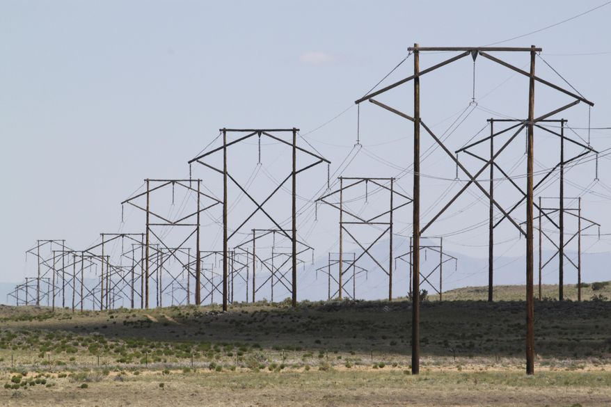 FILE - This May 20, 2012 photo shows one of the major transmission lines that runs to the west of Albuquerque, N.M. New Mexico's top prosecutor has opened an inquiry into utility costs during a winter blast that plunged New Mexico and other states into a deep freeze. State Attorney General Hector Balderas says the weather emergency caused tremendous damage and he wants to ensure New Mexicans won't be further harmed by skyrocketing bills. Utility executives testified Thursday, Feb. 25, 2021, that they were able to cushion some of the blow by shifting fuel sources, but higher natural gas prices ultimately will trickle down to customers through increases in their monthly bills. (AP Photo/Susan Montoya Bryan, File)